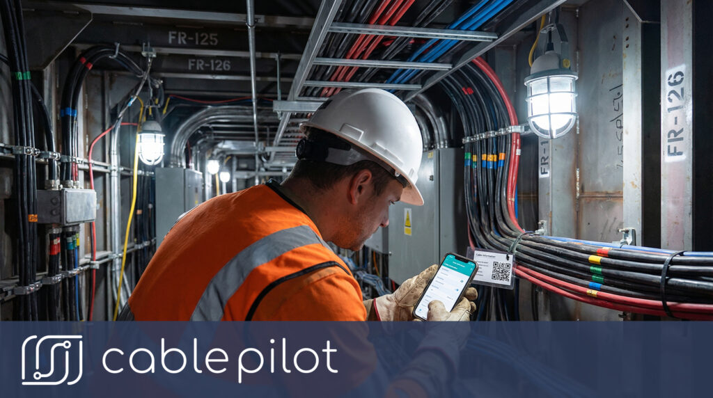 Marine electrical technician scanning a QR code for instant installation visibility and quality compliance tracking during shipboard electrical work.